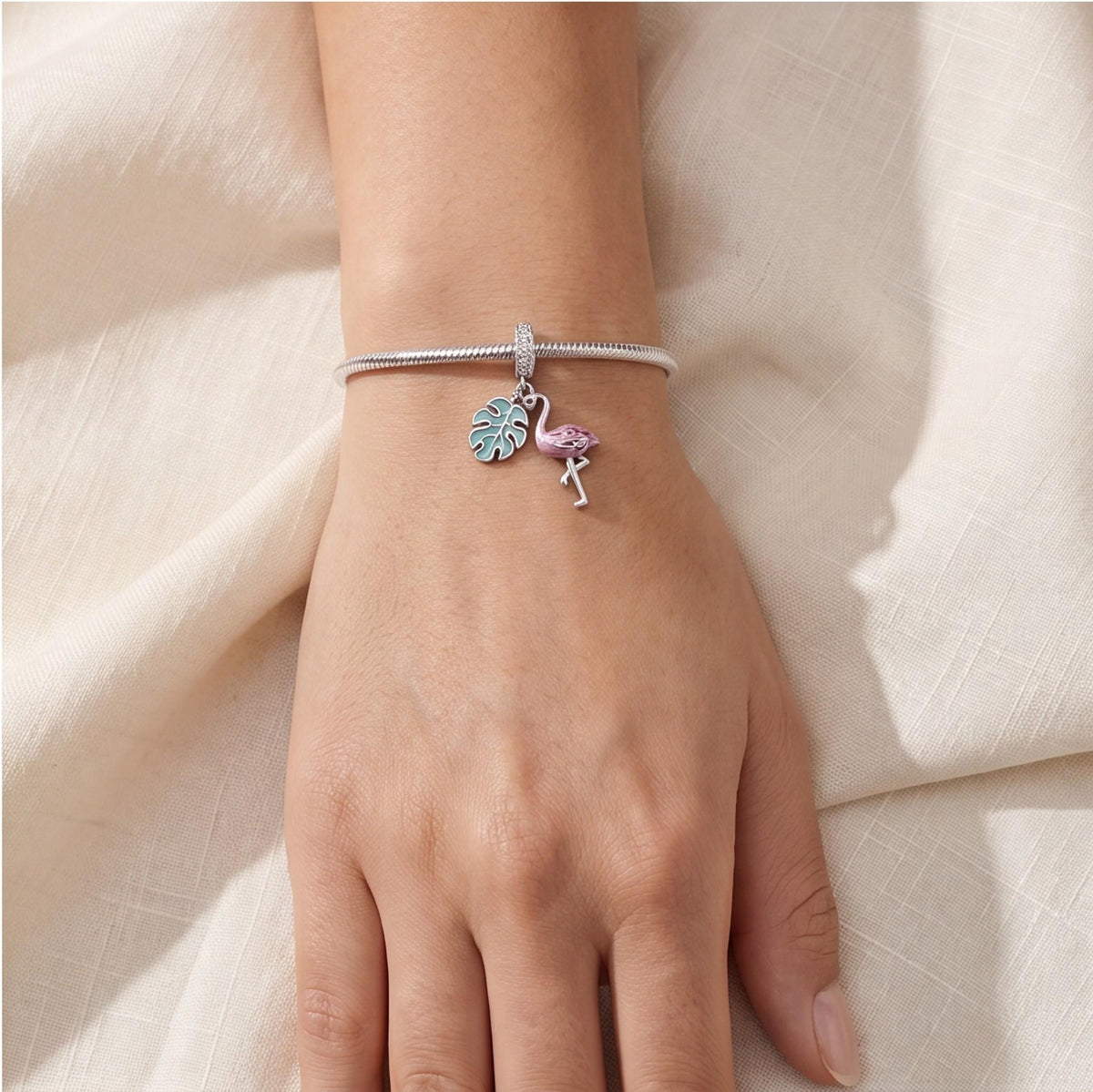 Flamingo Dangle Charm close-up on a bracelet