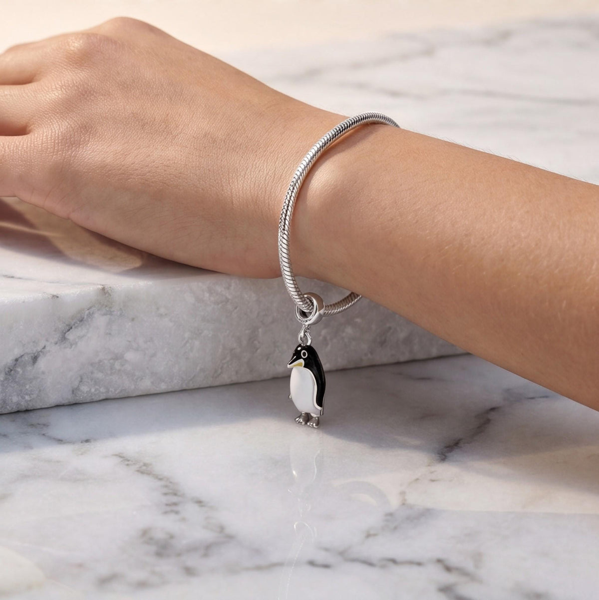 Penguin Dangle Charm worn on a charm bracelet