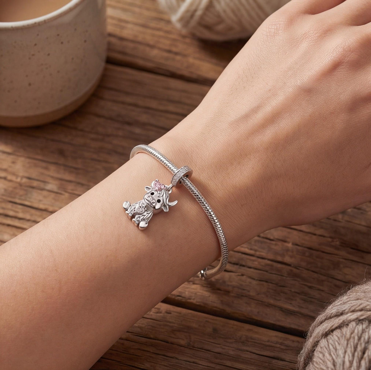 Highland Cow Dangle worn on a charm bracelet