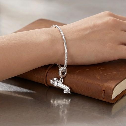 Lying Dachshund Dangle worn on a charm bracelet