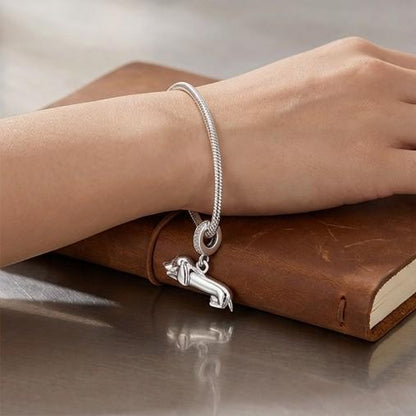 Lying Dachshund Dangle worn on a charm bracelet