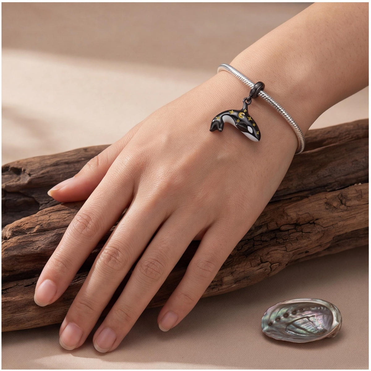 Celestial Orca Dangle worn on a charm bracelet