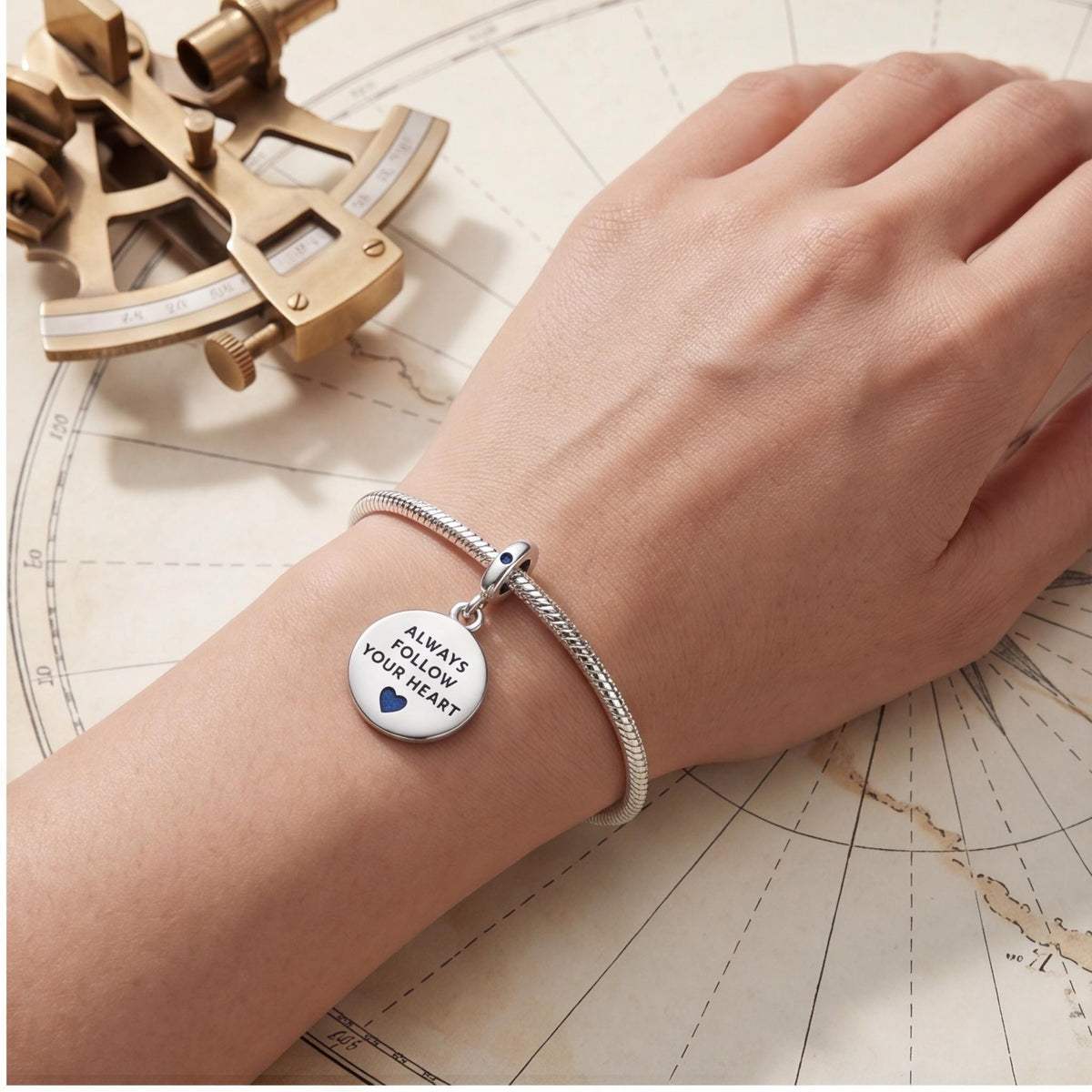 Compass Heart Dangle Charm on a silver charm bracelet