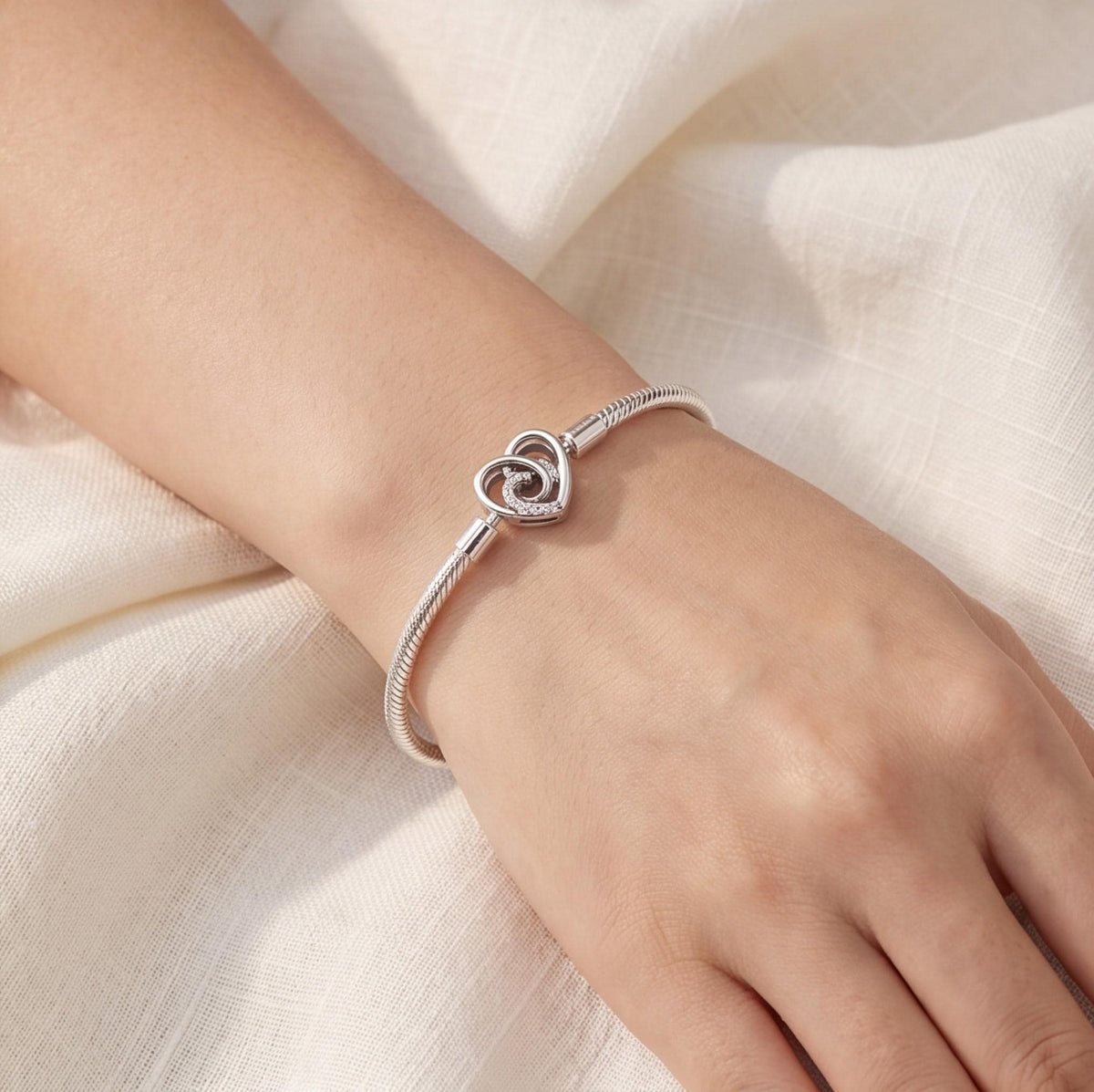 Sparkling Heart Clasp Charm worn on a charm bracelet