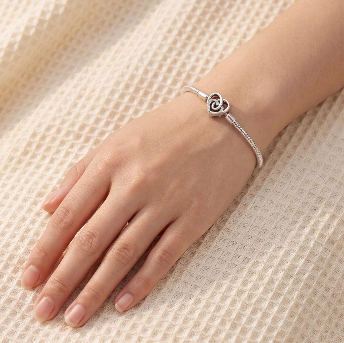 Sparkling Heart Clasp Charm close-up on a bracelet
