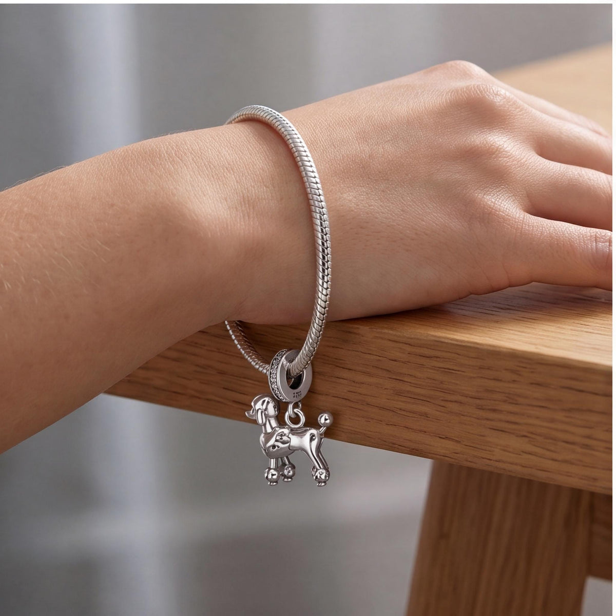 Poodle Dangle Charm on a silver charm bracelet