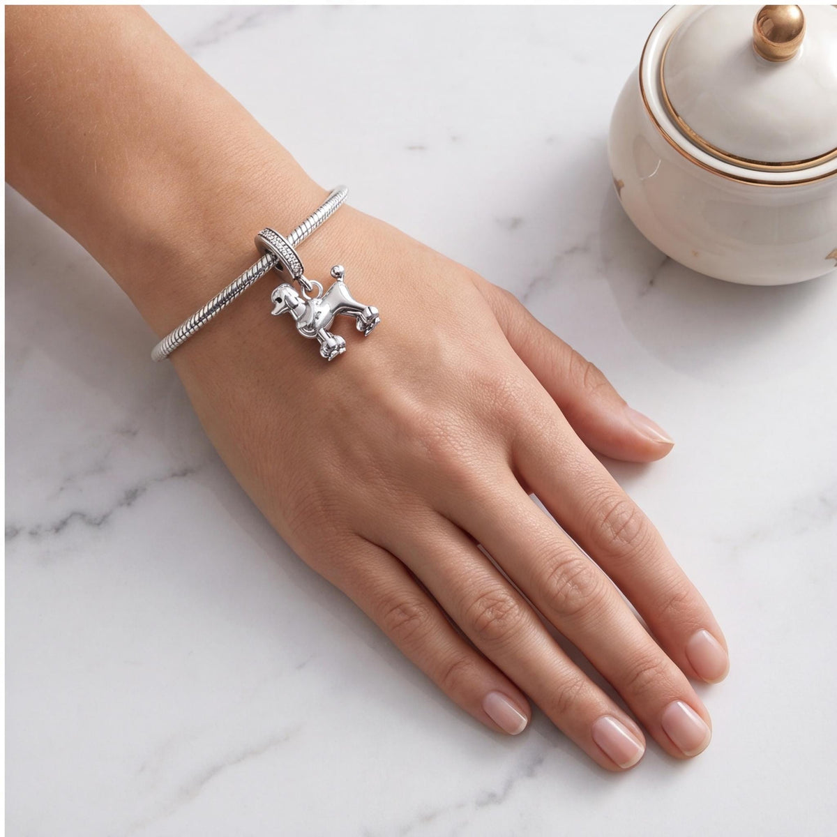 Poodle Dangle Charm worn on a charm bracelet