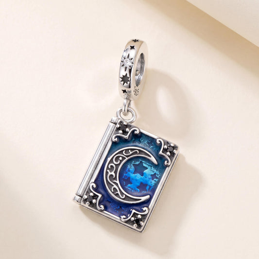 Magic Book Moon Charm in 925 sterling silver with blue and black enamel and sparkling stones