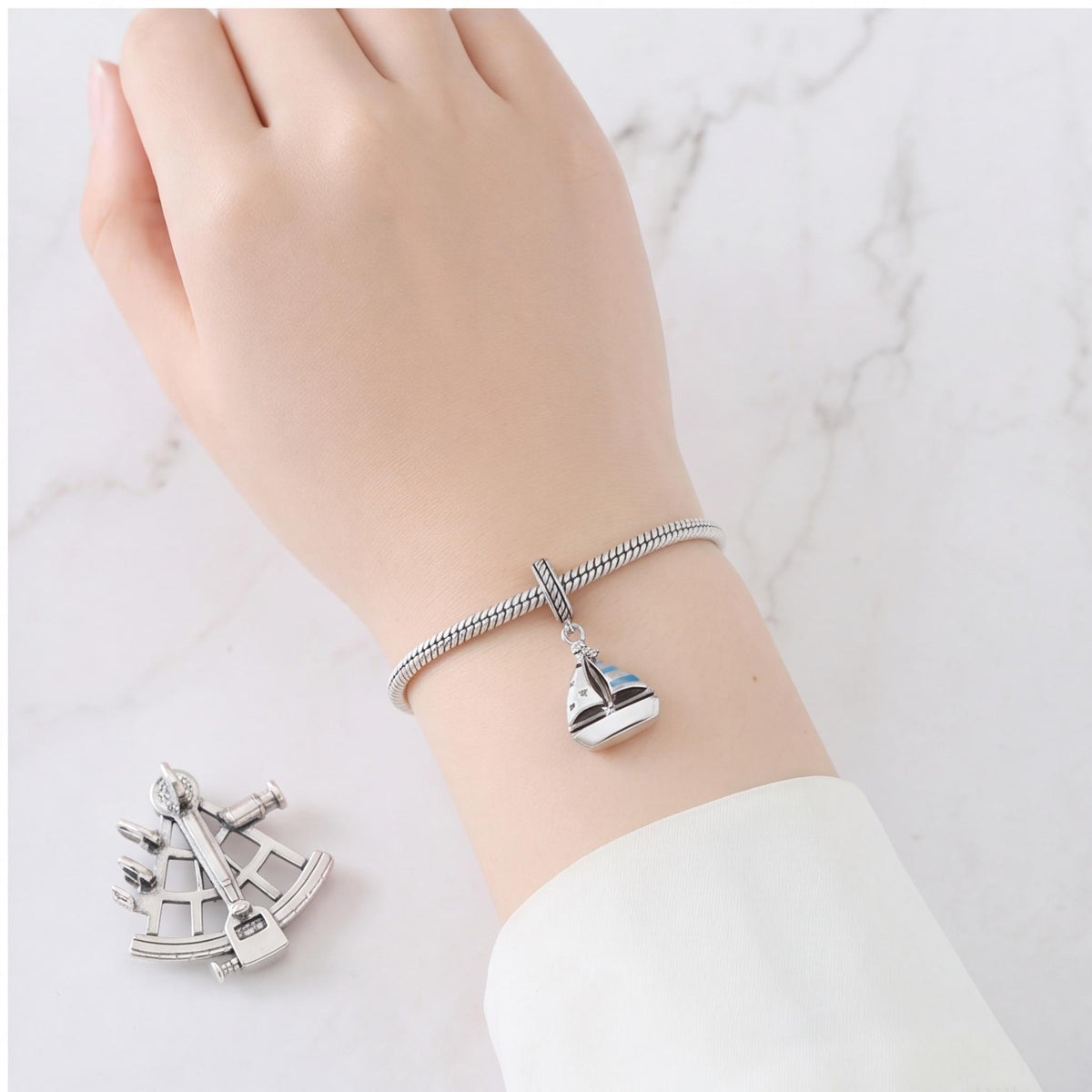 Sailboat Dangle Charm close-up on a bracelet