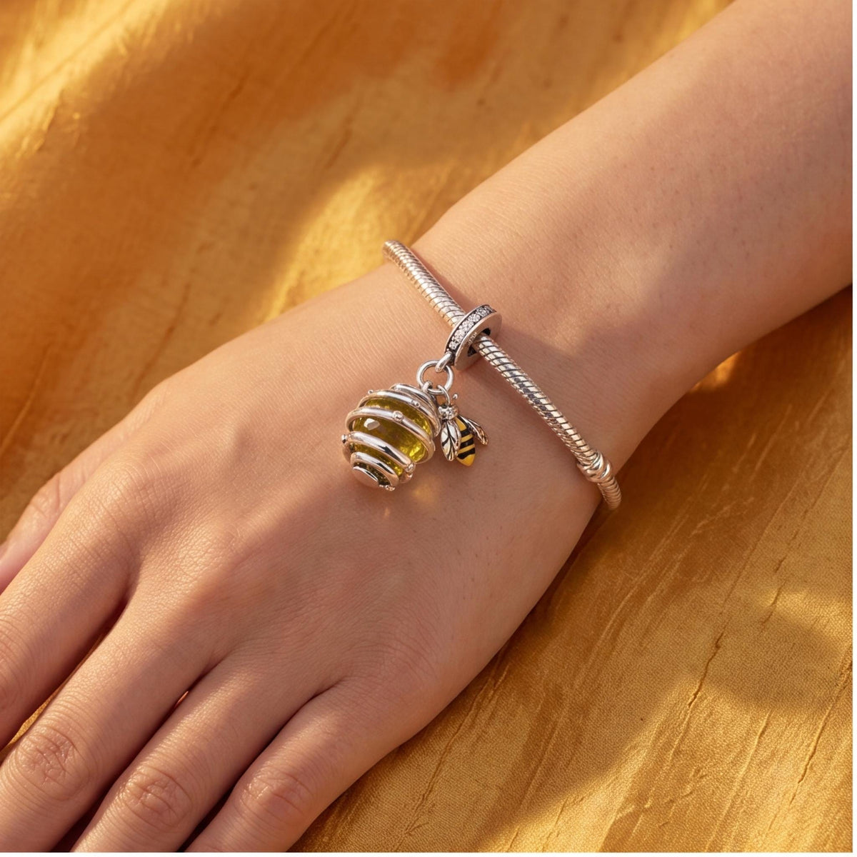 Bee Hive Dangle Charm close-up on a bracelet