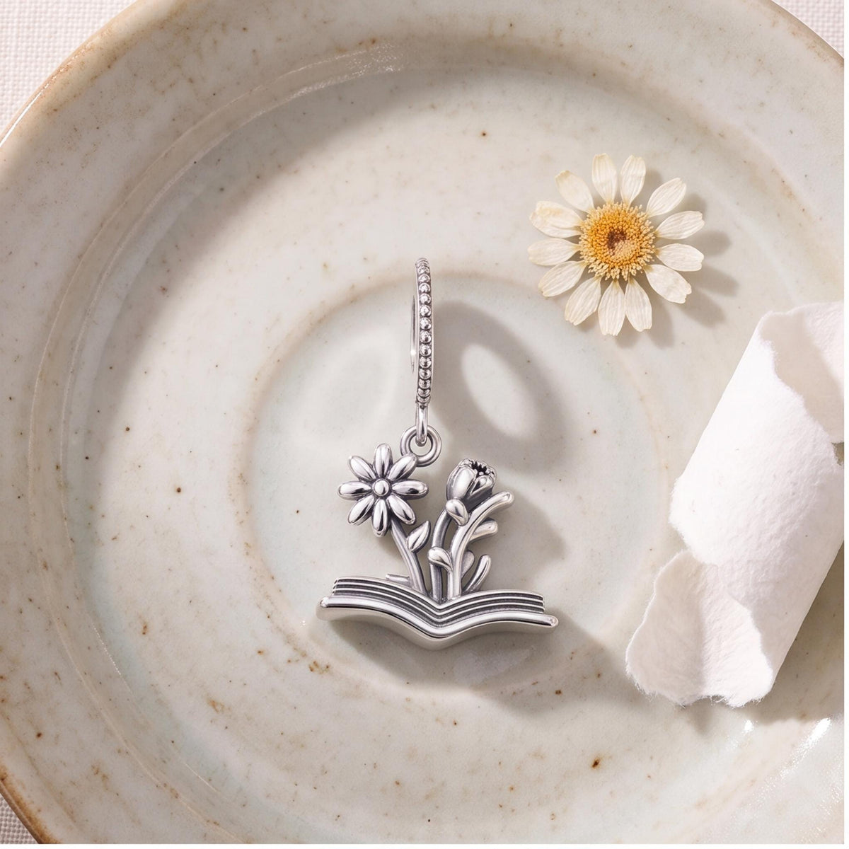 Flower Book Charm close-up on a bracelet