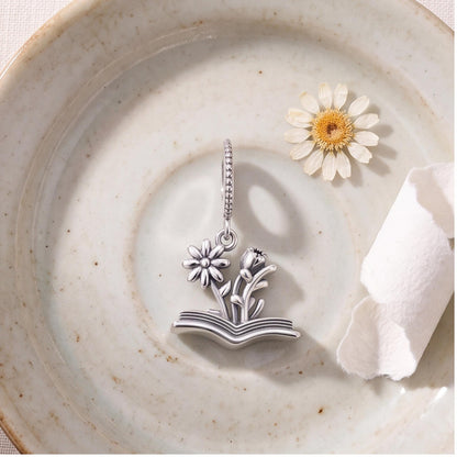 Flower Book Charm close-up on a bracelet