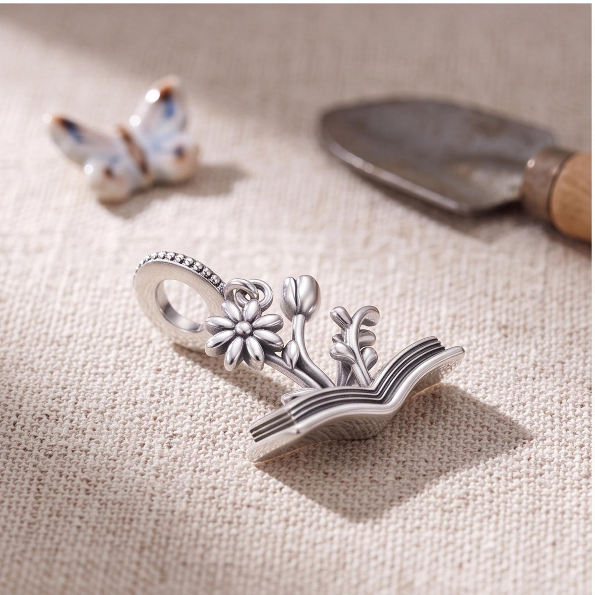 Flower Book Charm on a silver charm bracelet