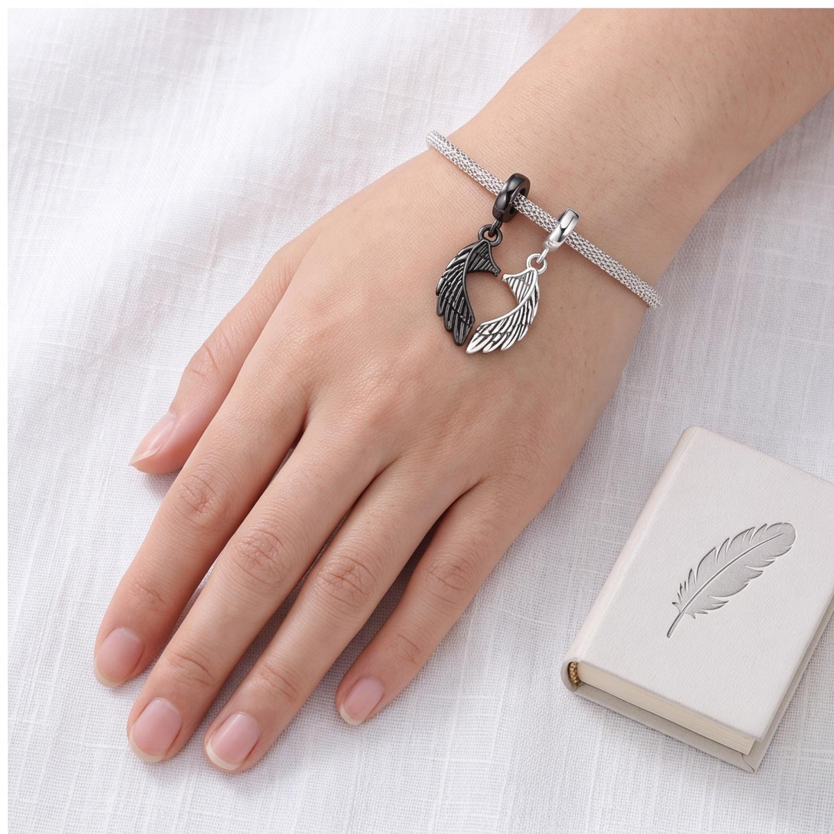 Angel Wing Dangle Charm worn on a charm bracelet