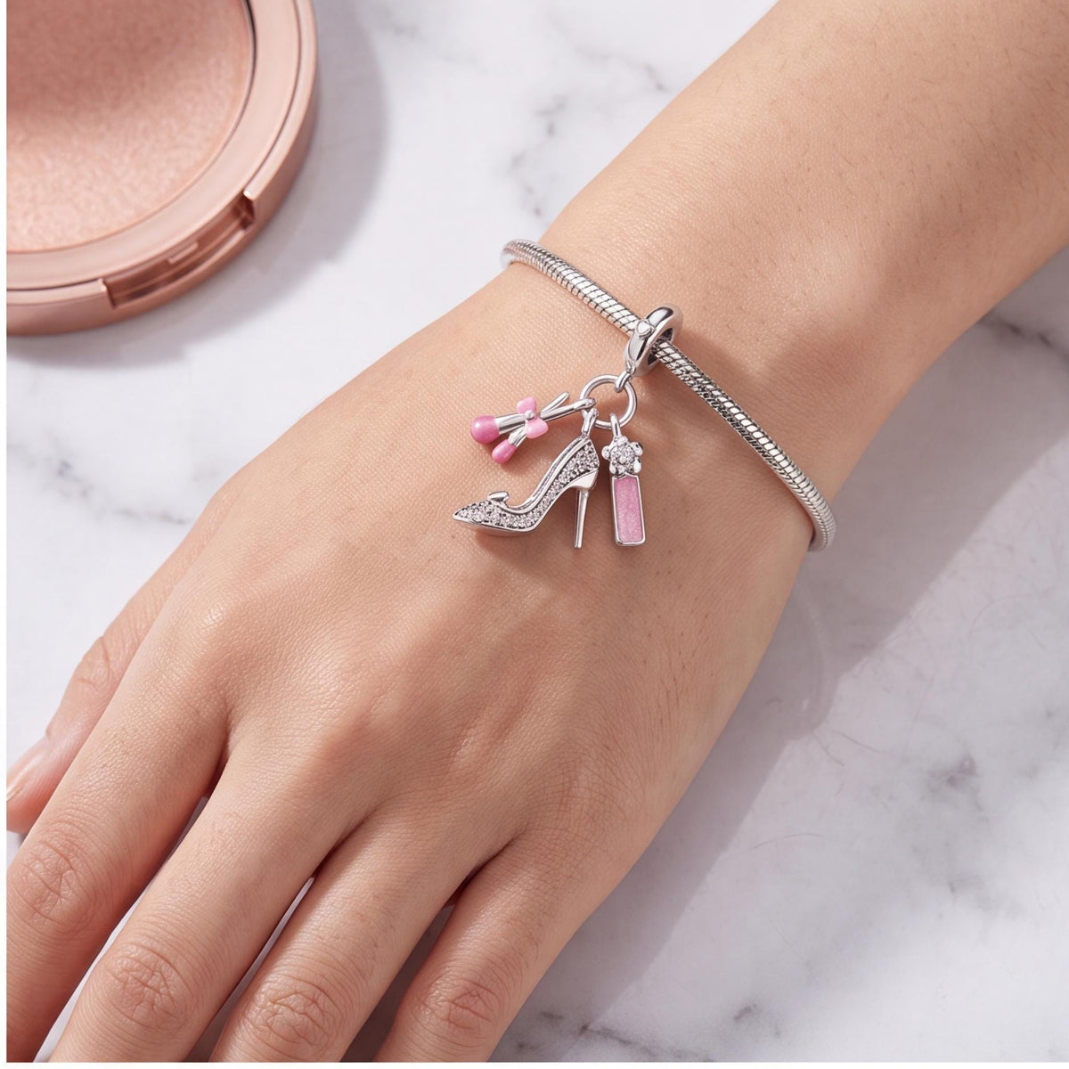Glam Makeup Dangle Charm worn on a charm bracelet