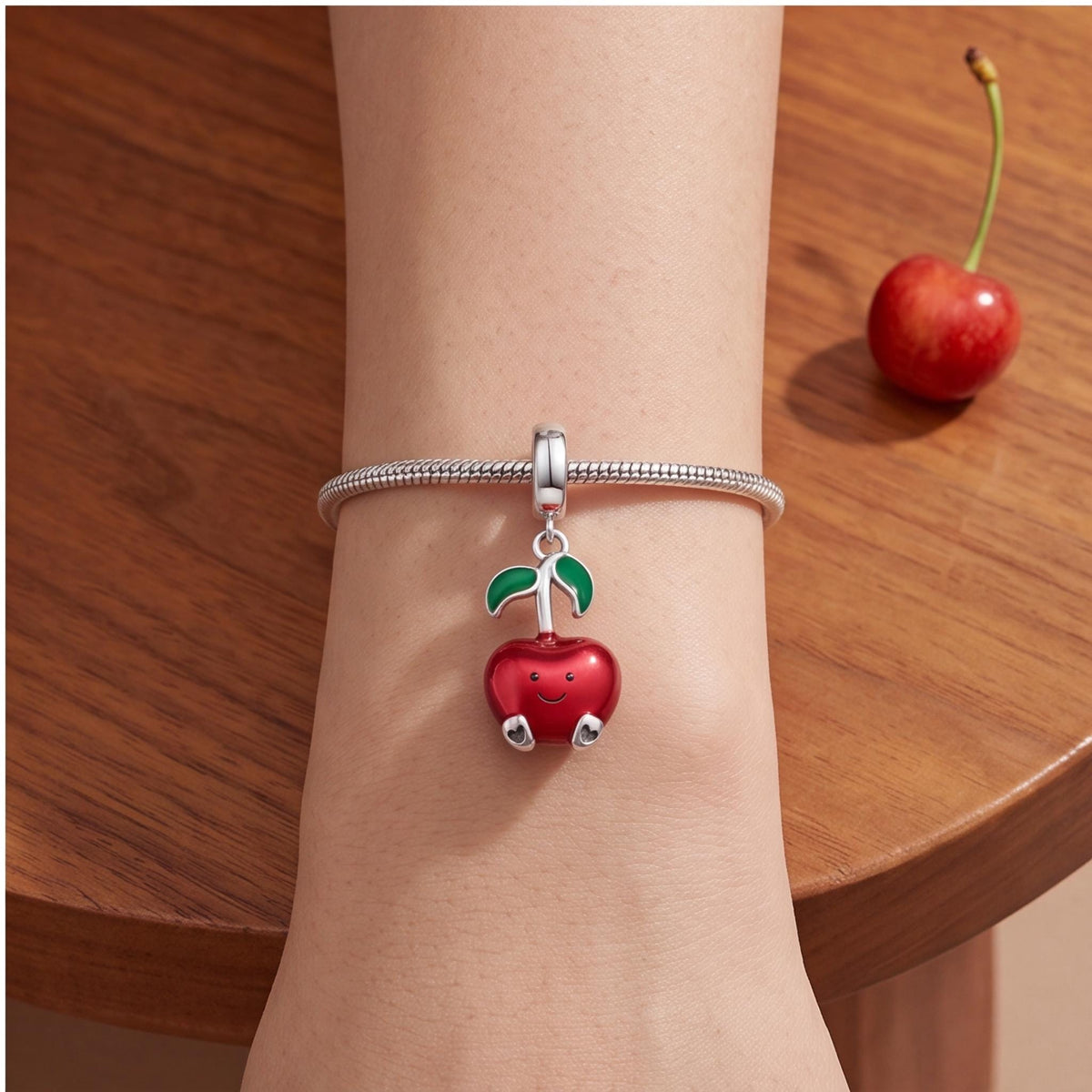 Smiley Apple Dangle Charm close-up on a bracelet