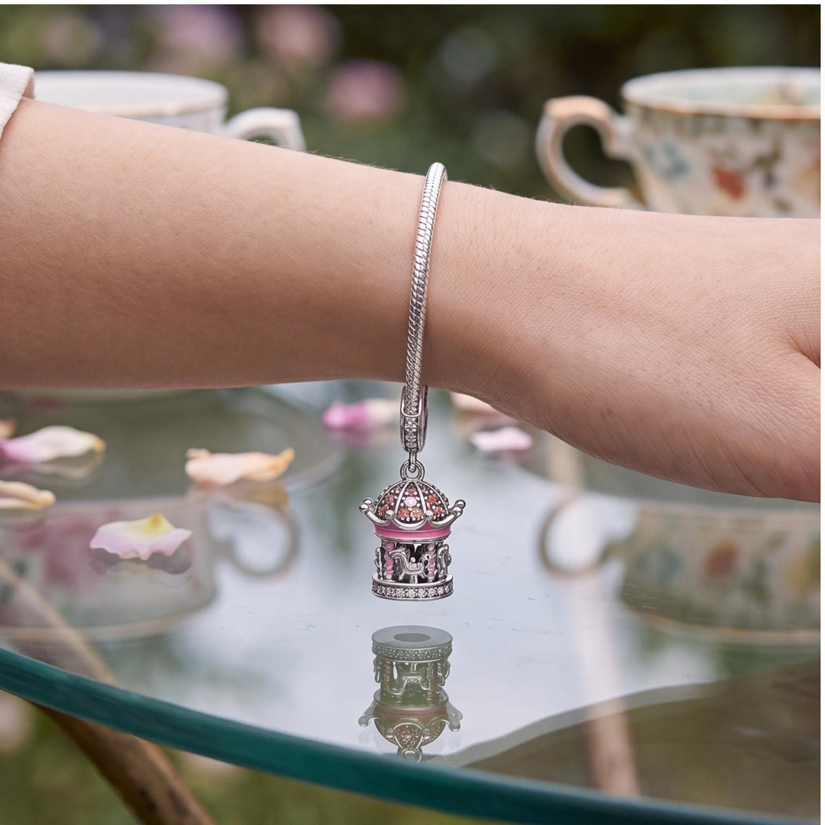 Pink Fairground Carousel Dangle worn on a charm bracelet