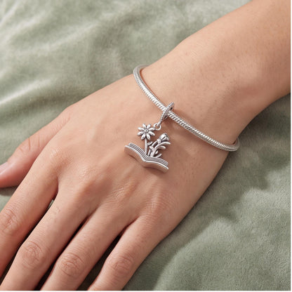 Flower Book Charm worn on a charm bracelet