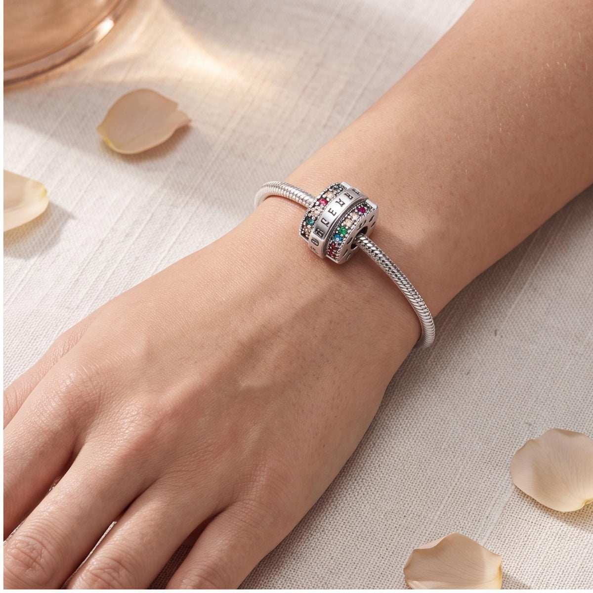 Forever Rainbow Clip worn on a charm bracelet