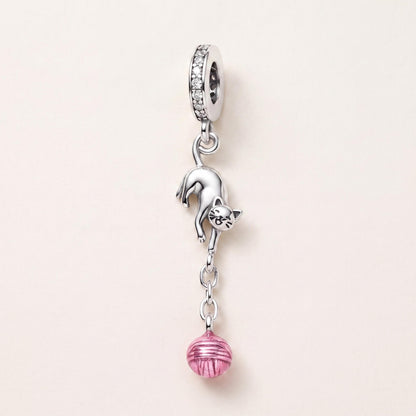 Playful Cat Yarn Charm in 925 sterling silver with pink enamel and sparkling stones, fits European-style charm bracelets