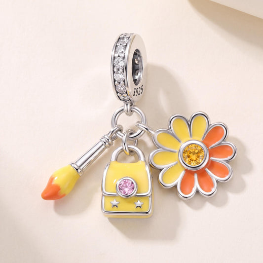 Daisy Paintbrush Dangle in 925 sterling silver with yellow and orange enamel and sparkling stones
