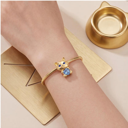 Cat Holding Heart Charm close-up on a bracelet