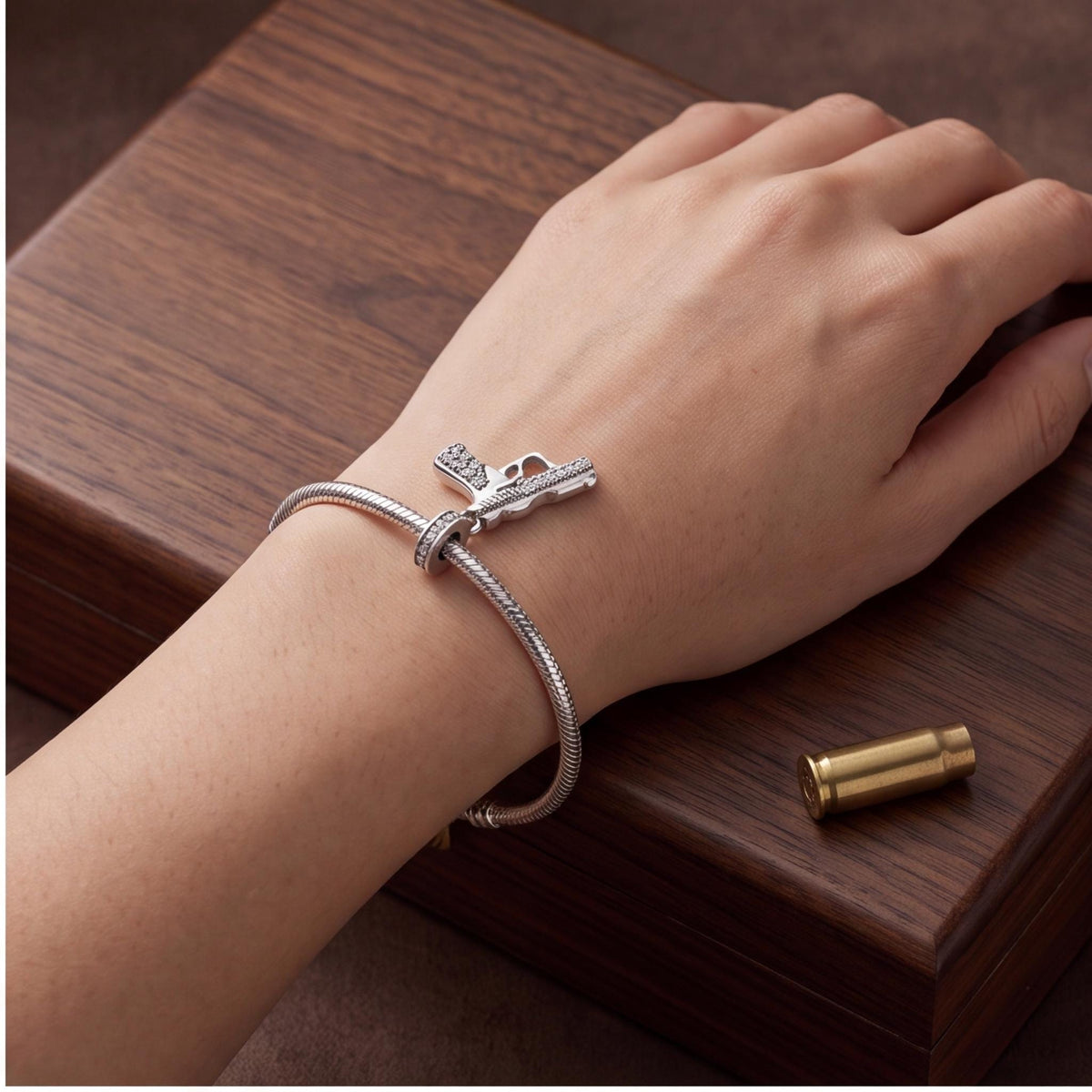Gun Dangle Charm close-up on a bracelet