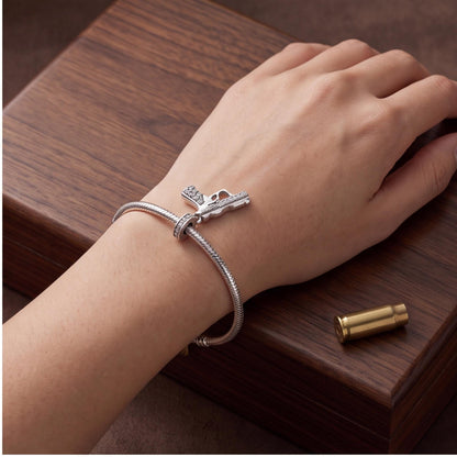 Gun Dangle Charm close-up on a bracelet