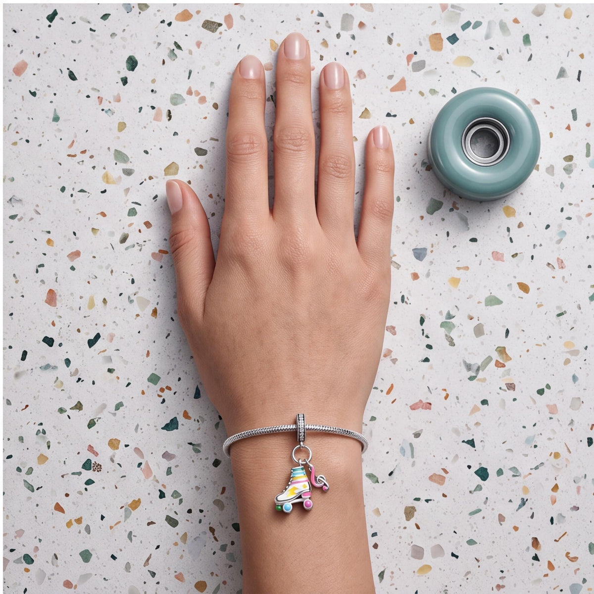 Roller Skate Dangle Charm worn on a charm bracelet