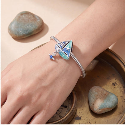 Blue Sailboat Charm close-up on a bracelet