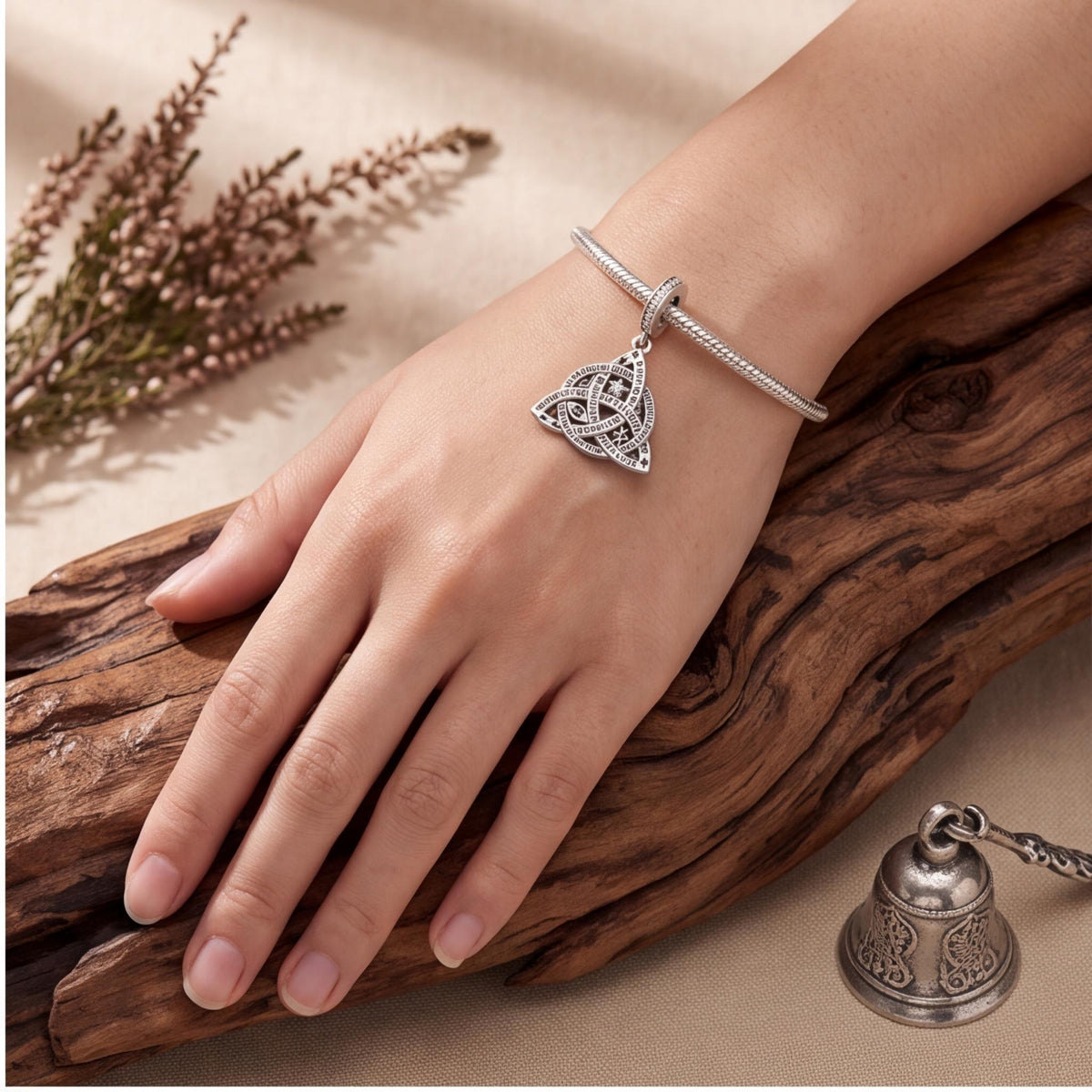 Trinity Knot Charm worn on a charm bracelet