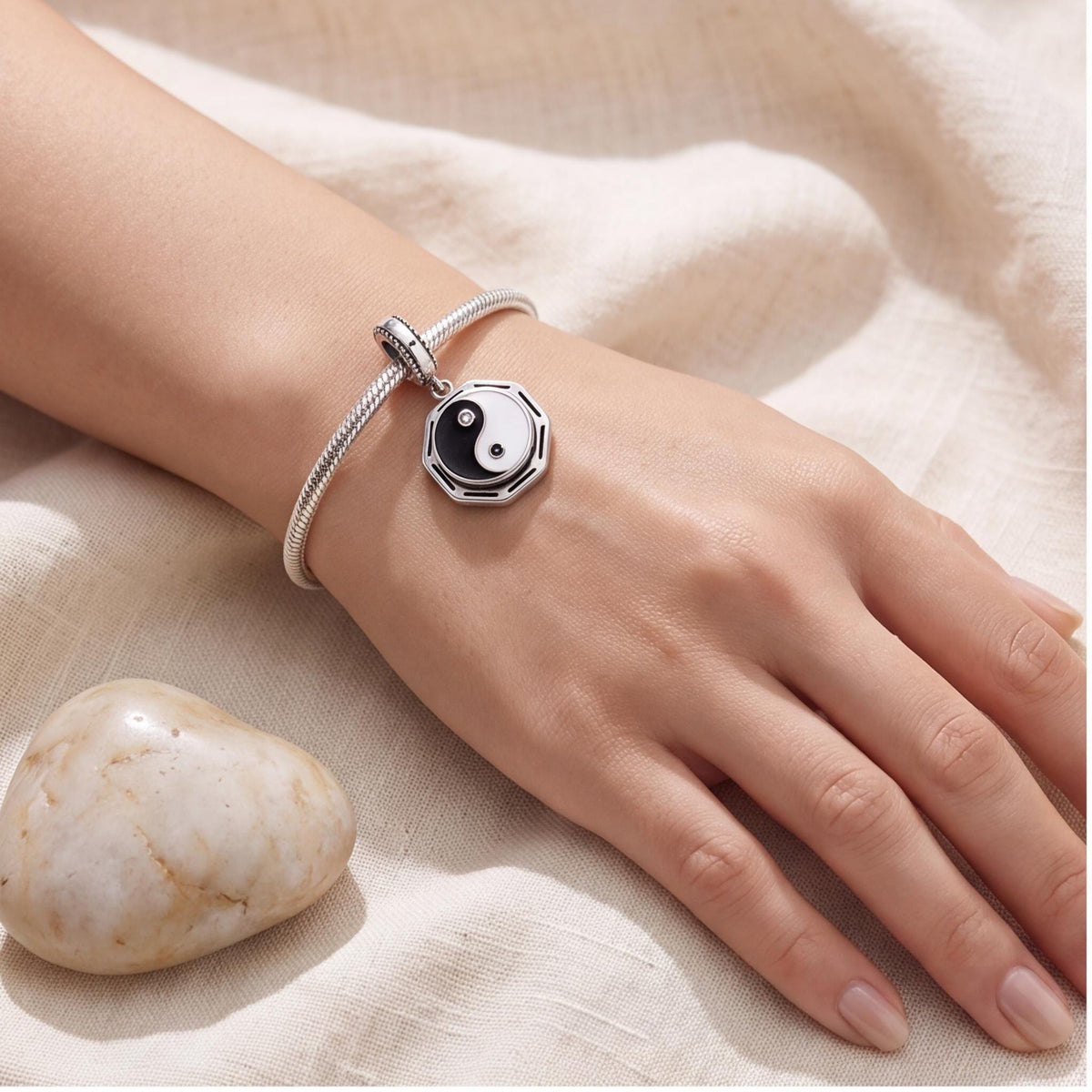 Yin Yang Bagua Charm worn on a charm bracelet