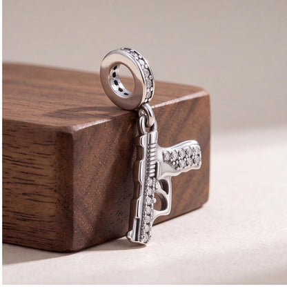 Gun Dangle Charm styled as a gift