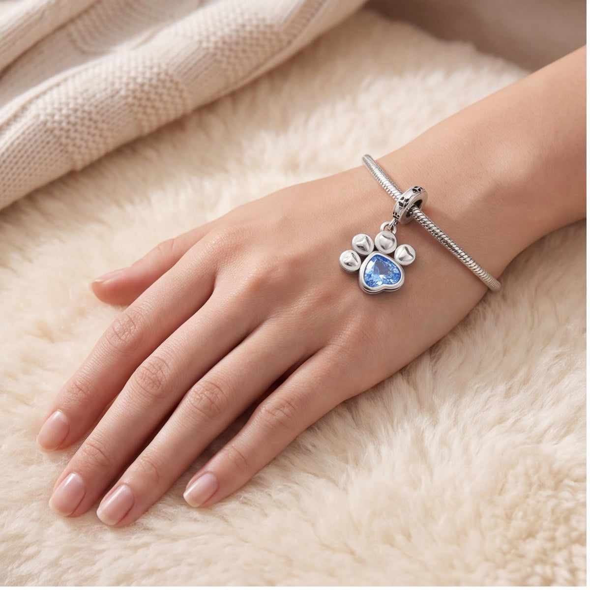 Paw Print Dangle Charm worn on a charm bracelet