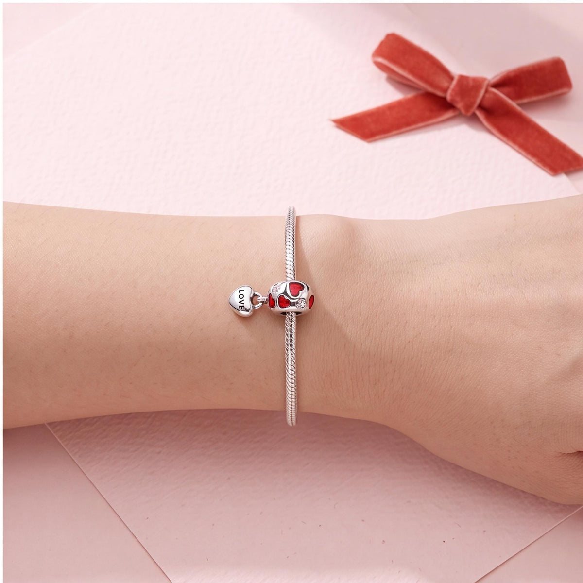Red Enamel Love Heart Charm worn on a charm bracelet