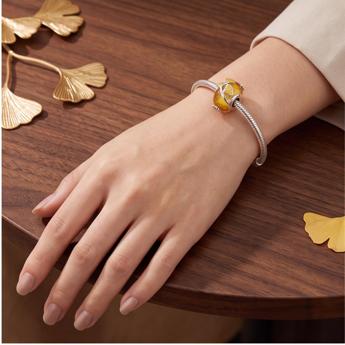 Ginkgo Leaf Bead worn on a charm bracelet