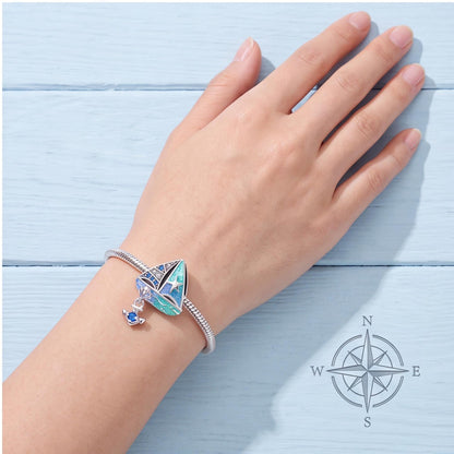 Blue Sailboat Charm worn on a charm bracelet