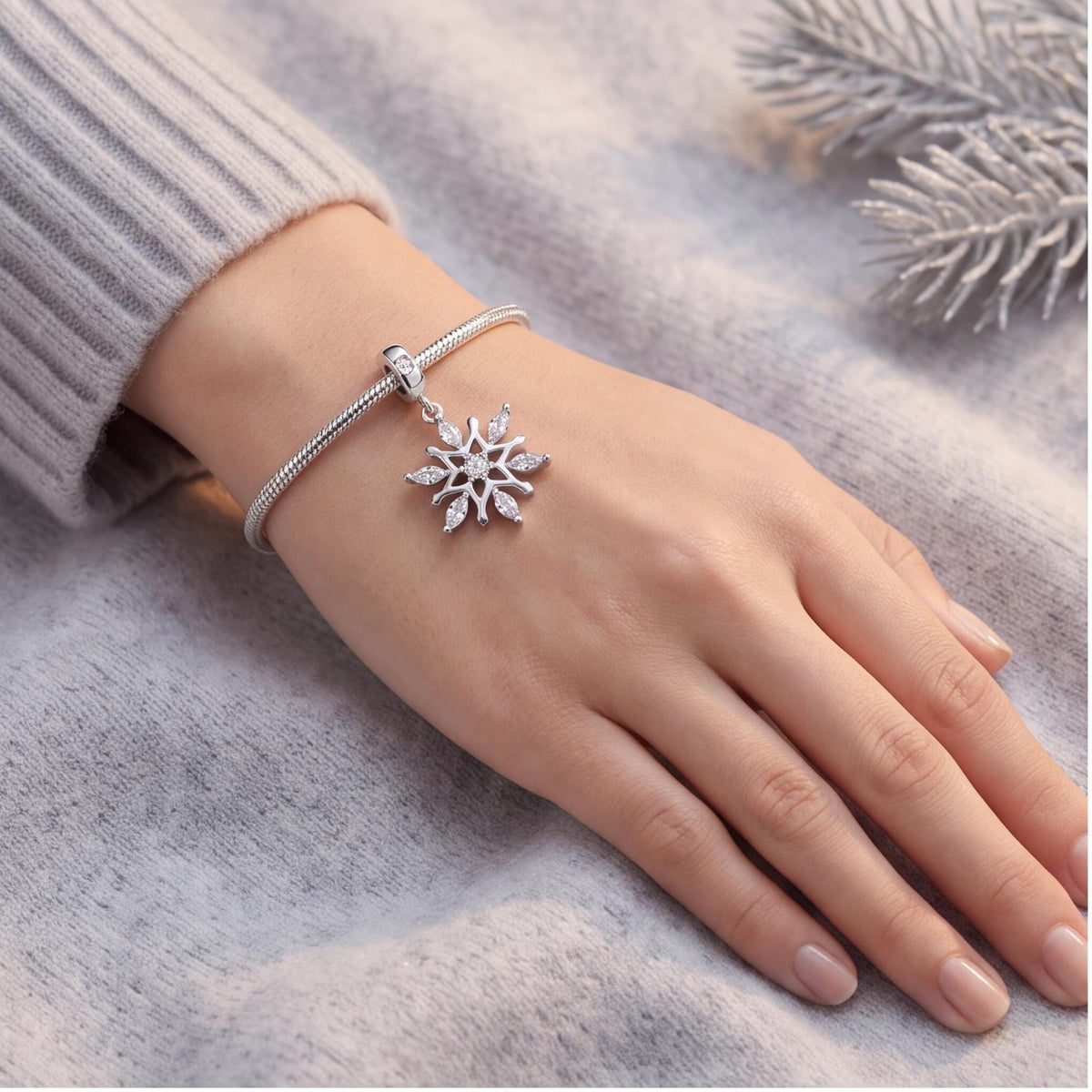 Snowflake Dangle Charm close-up on a bracelet