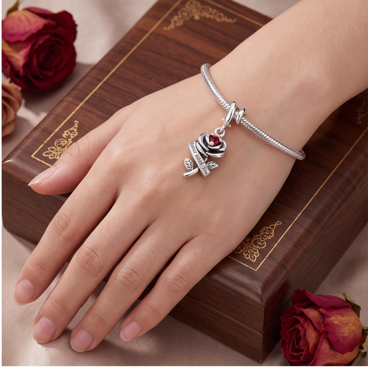 Red Rose Dangle Charm close-up on a bracelet