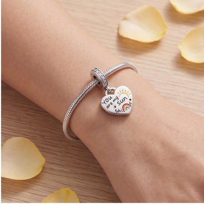 Sunshine Heart Dangle worn on a charm bracelet