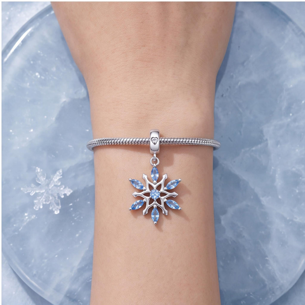 Blue Snowflake Charm worn on a charm bracelet