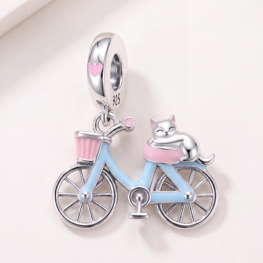 Cat on Bicycle Dangle in 925 sterling silver with blue and pink enamel, fits European-style charm bracelets