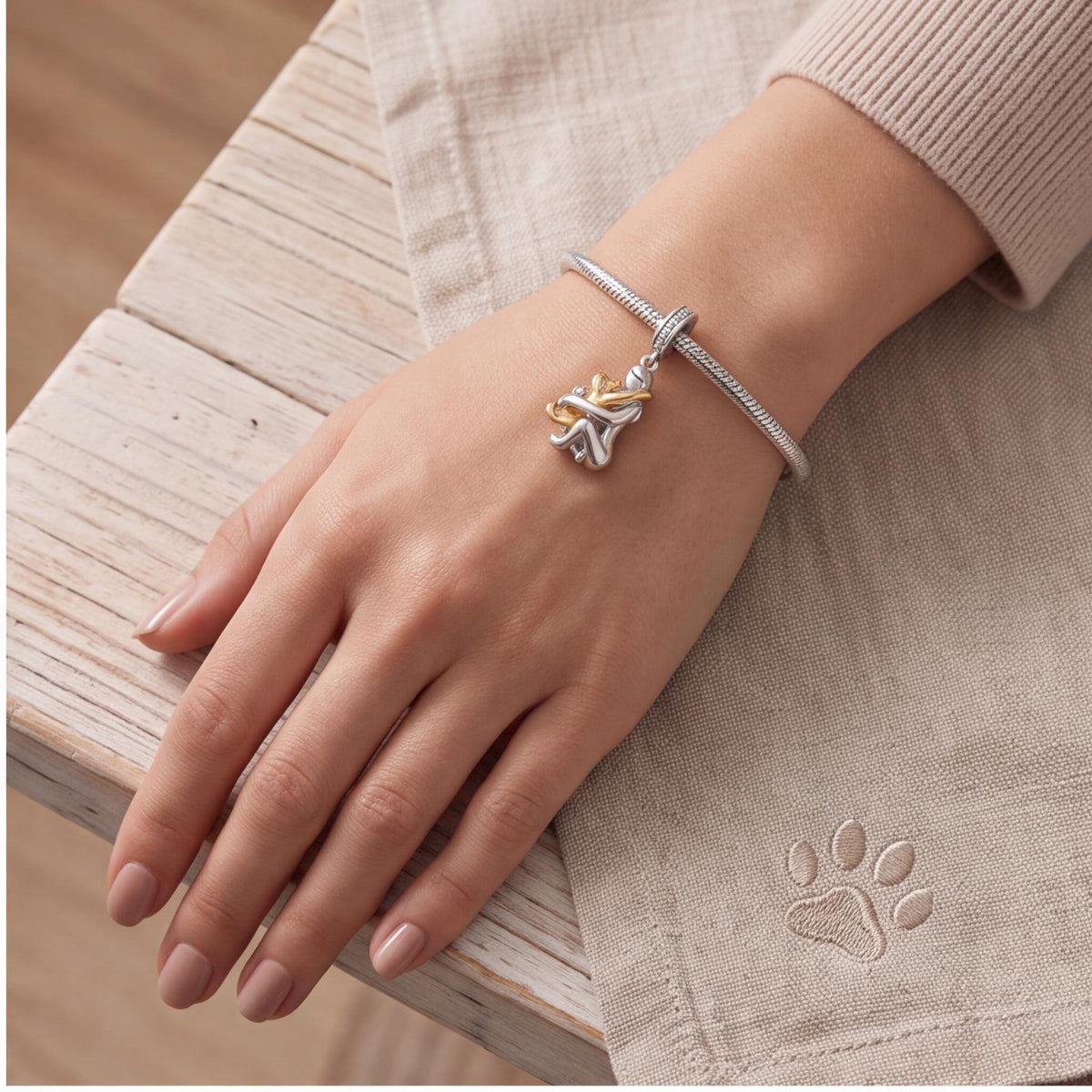 Girl Hugging Dog Charm close-up on a bracelet