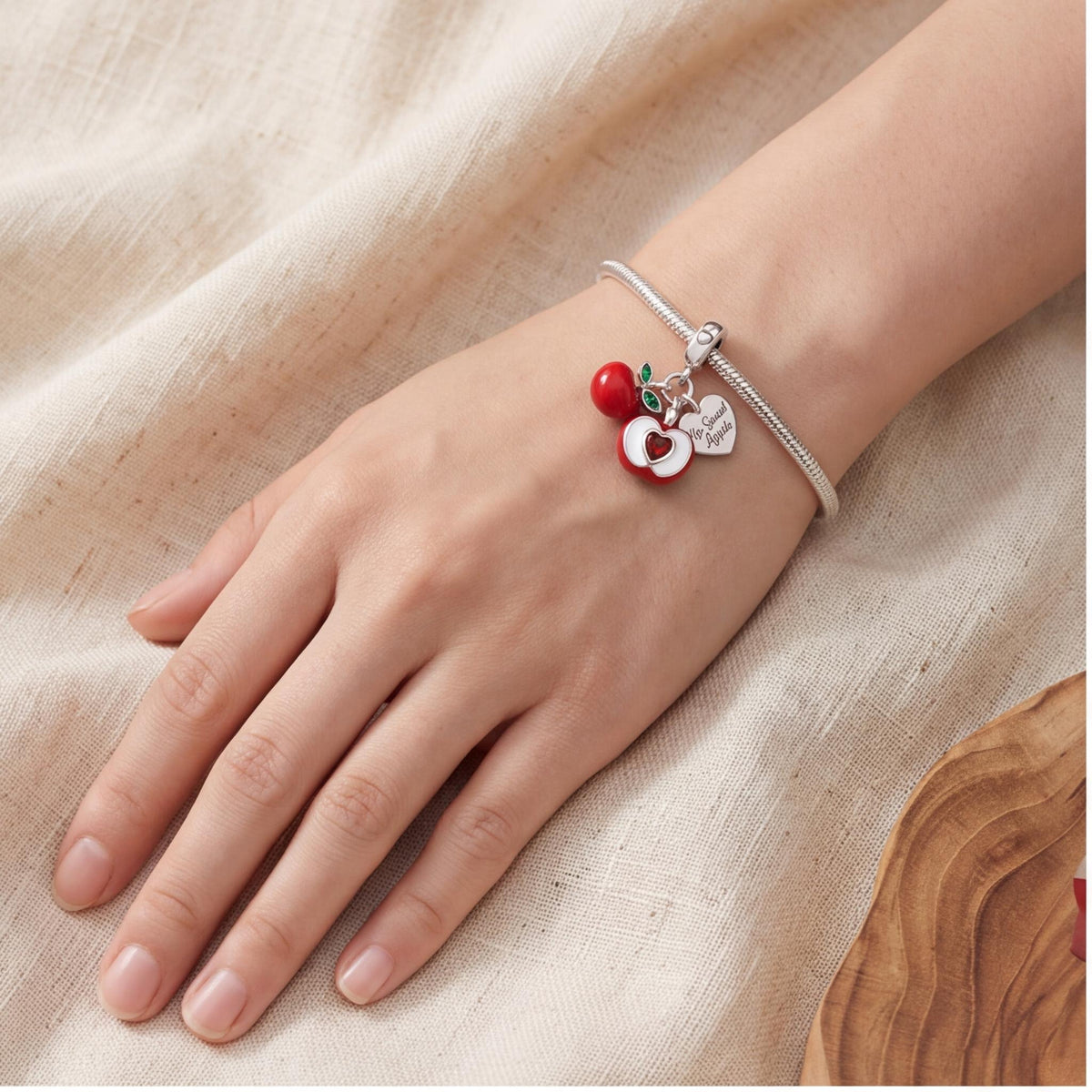 Red Apple Dangle Charm close-up on a bracelet
