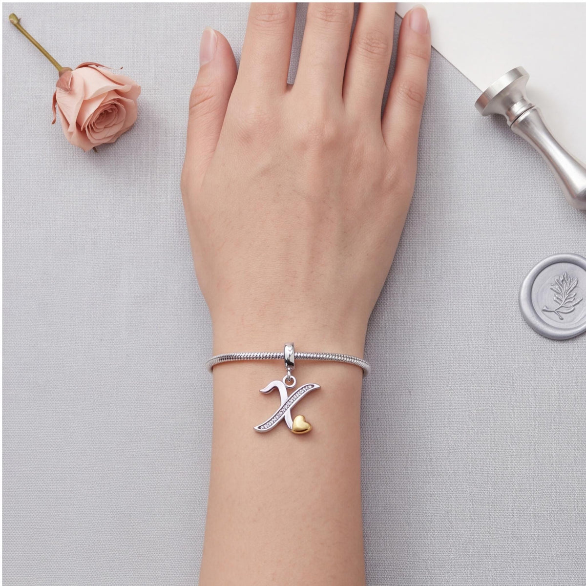 Letter X Initial Charm close-up on a bracelet