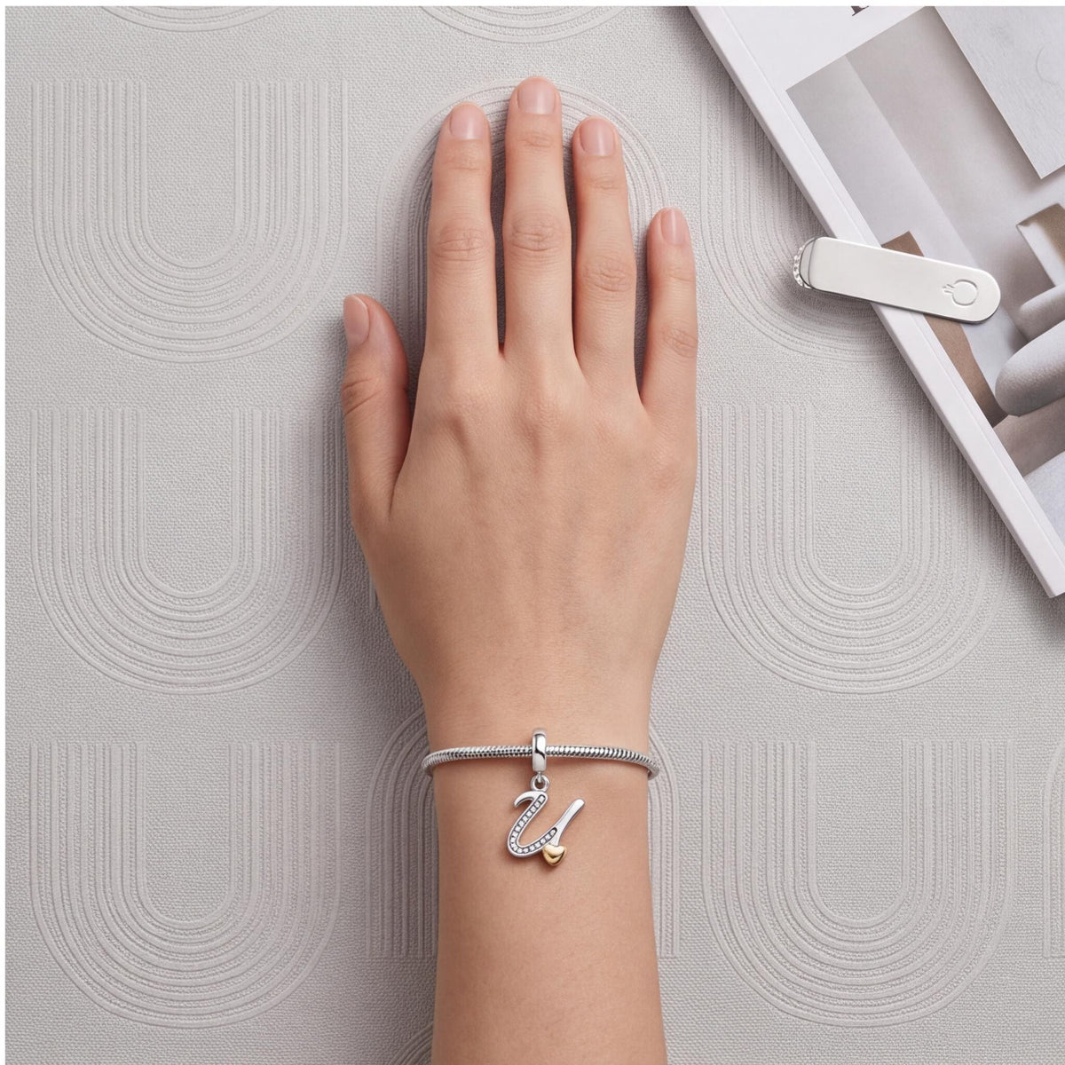 Letter U Dangle Charm worn on a charm bracelet