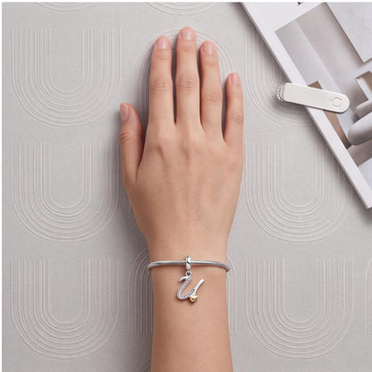 Letter U Dangle Charm worn on a charm bracelet