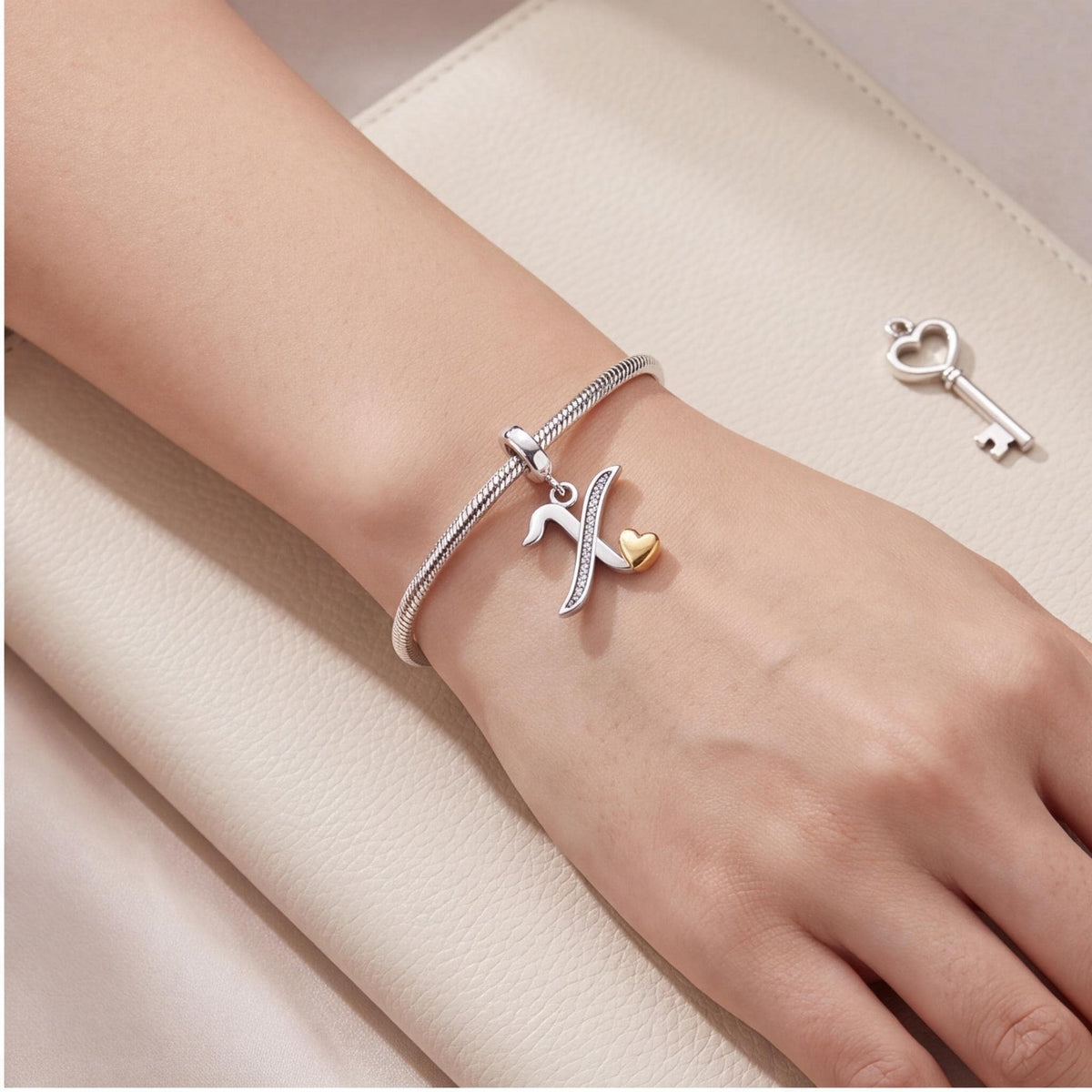 Letter X Initial Charm worn on a charm bracelet
