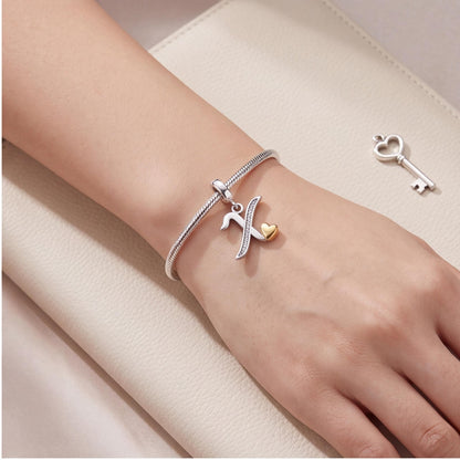 Letter X Initial Charm worn on a charm bracelet