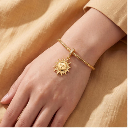 Sun Face Dangle Charm close-up on a bracelet